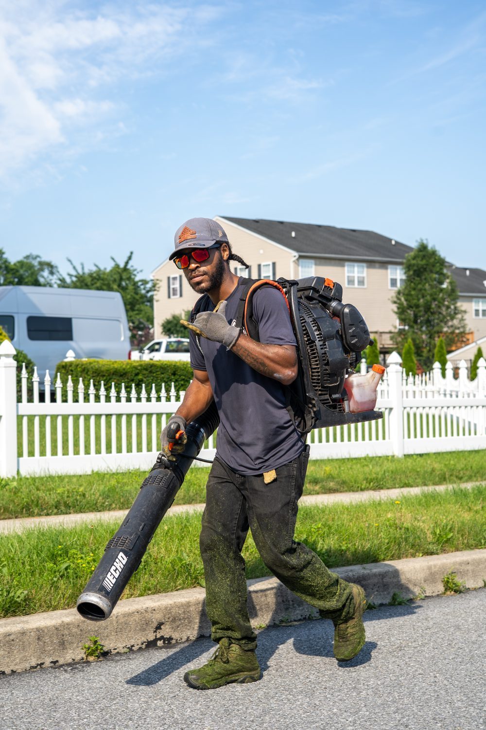 An Anderson Lawn Care crew member on the job in a local neighborhood